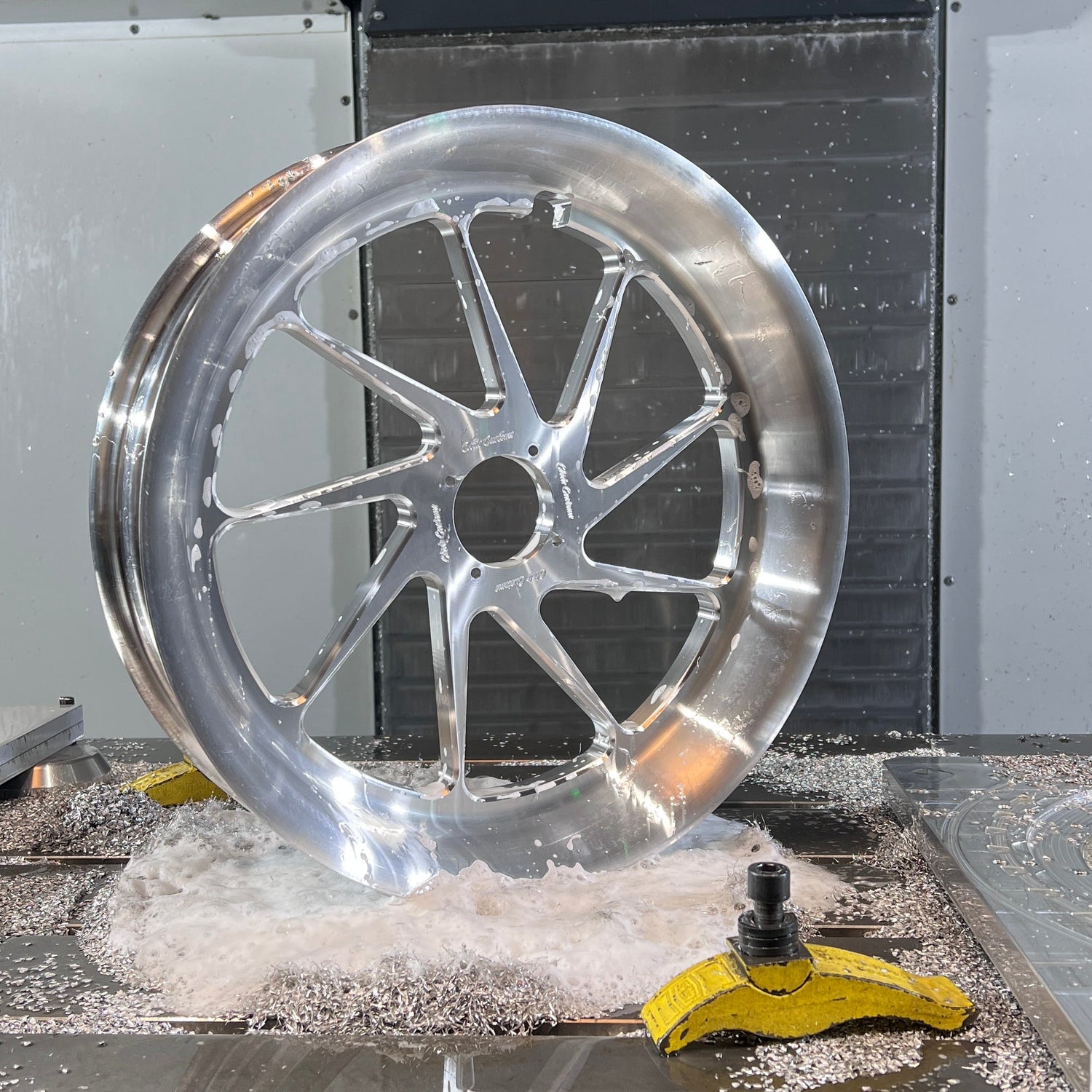 Metallic wheel rim being machined on a CNC machine