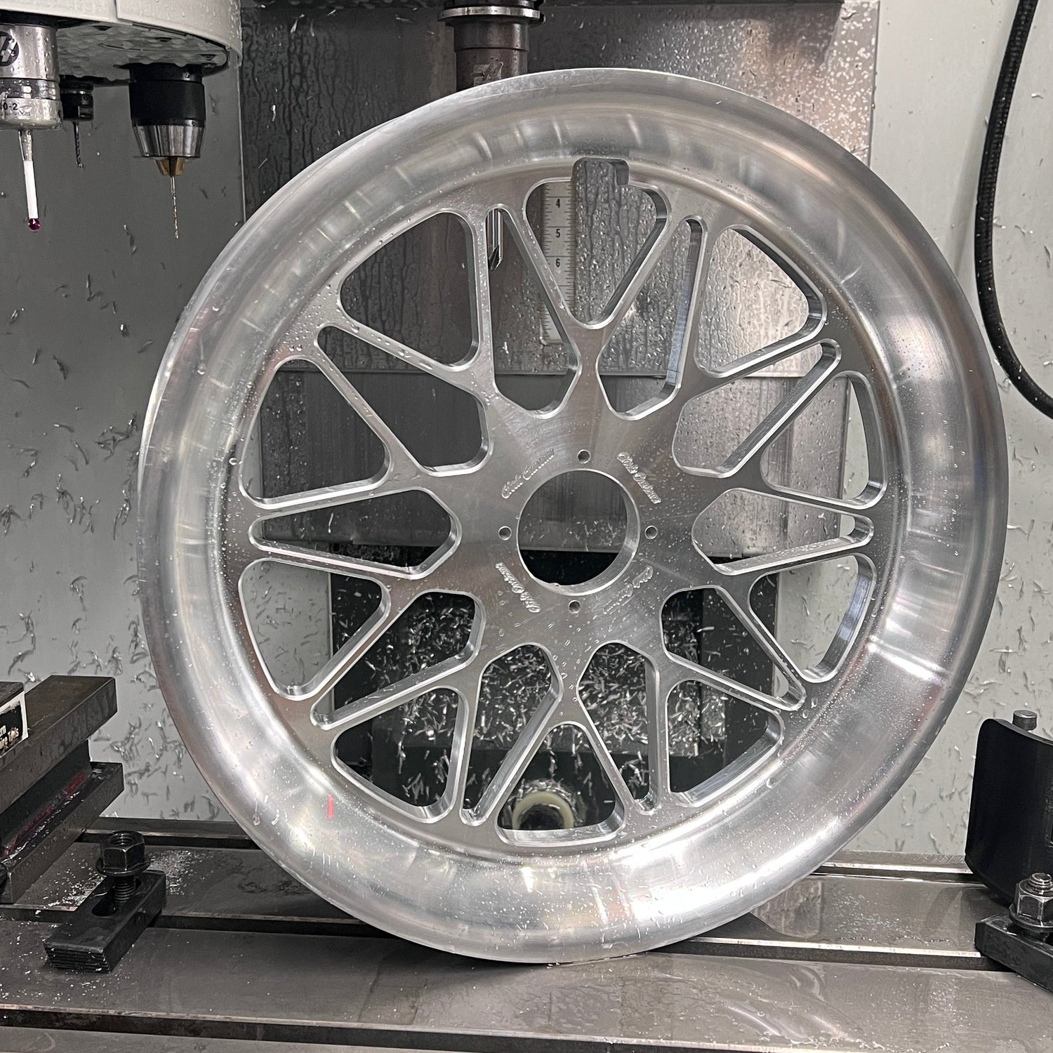 Metallic wheel rim being machined on a lathe