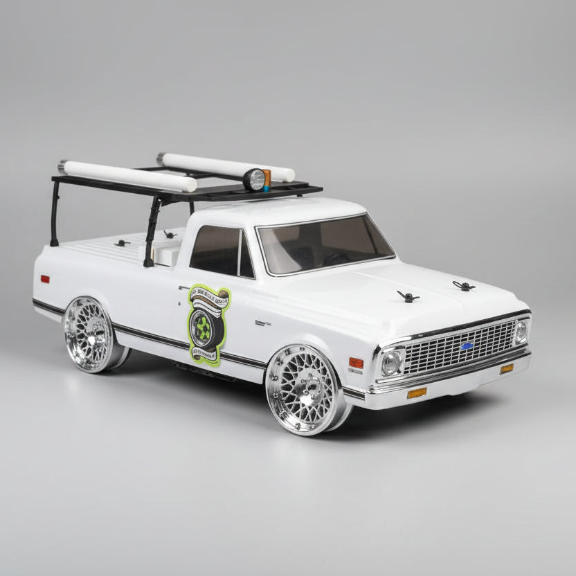 Model truck with roof rack on a wooden surface in a workshop setting