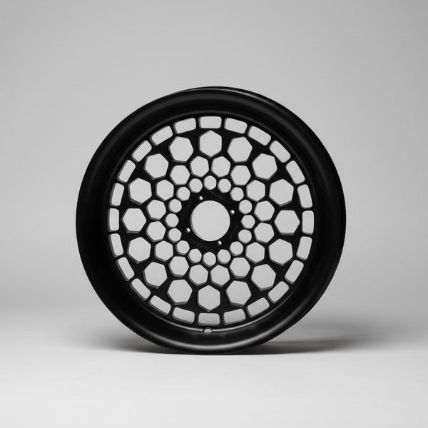Black decorative wheel on a wooden surface with 'Chris Customs' branding in the background.