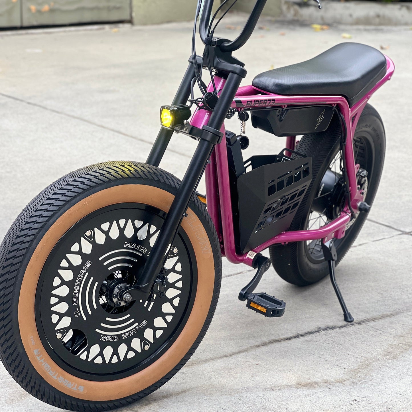 Black and pink electric bike on a concrete surface