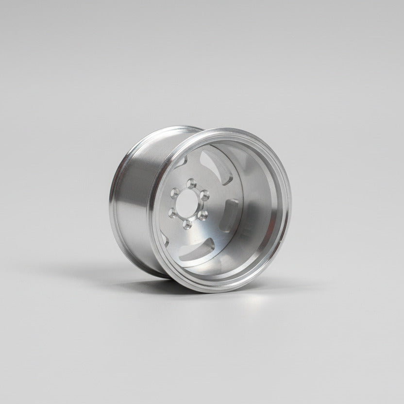 Silver metallic wheel rim on a light gray background