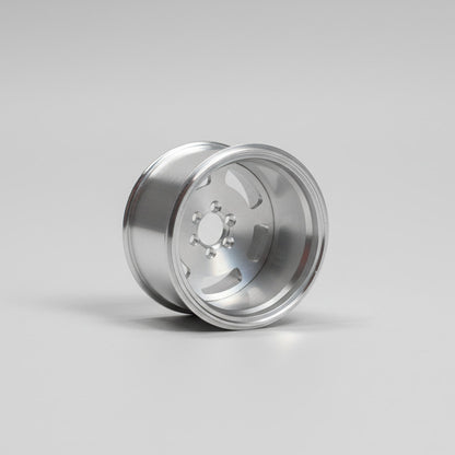 Silver metallic wheel rim on a light gray background