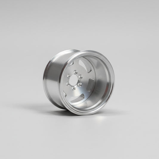 Silver metallic wheel rim on a light gray background