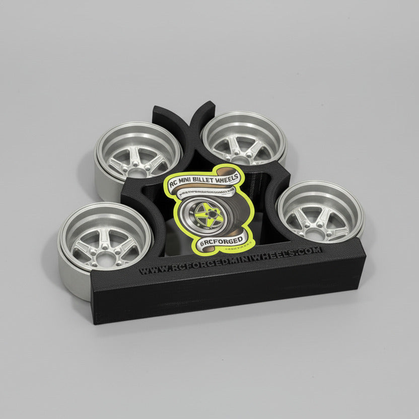 Set of model wheels on a display stand with a sticker on a cutting mat