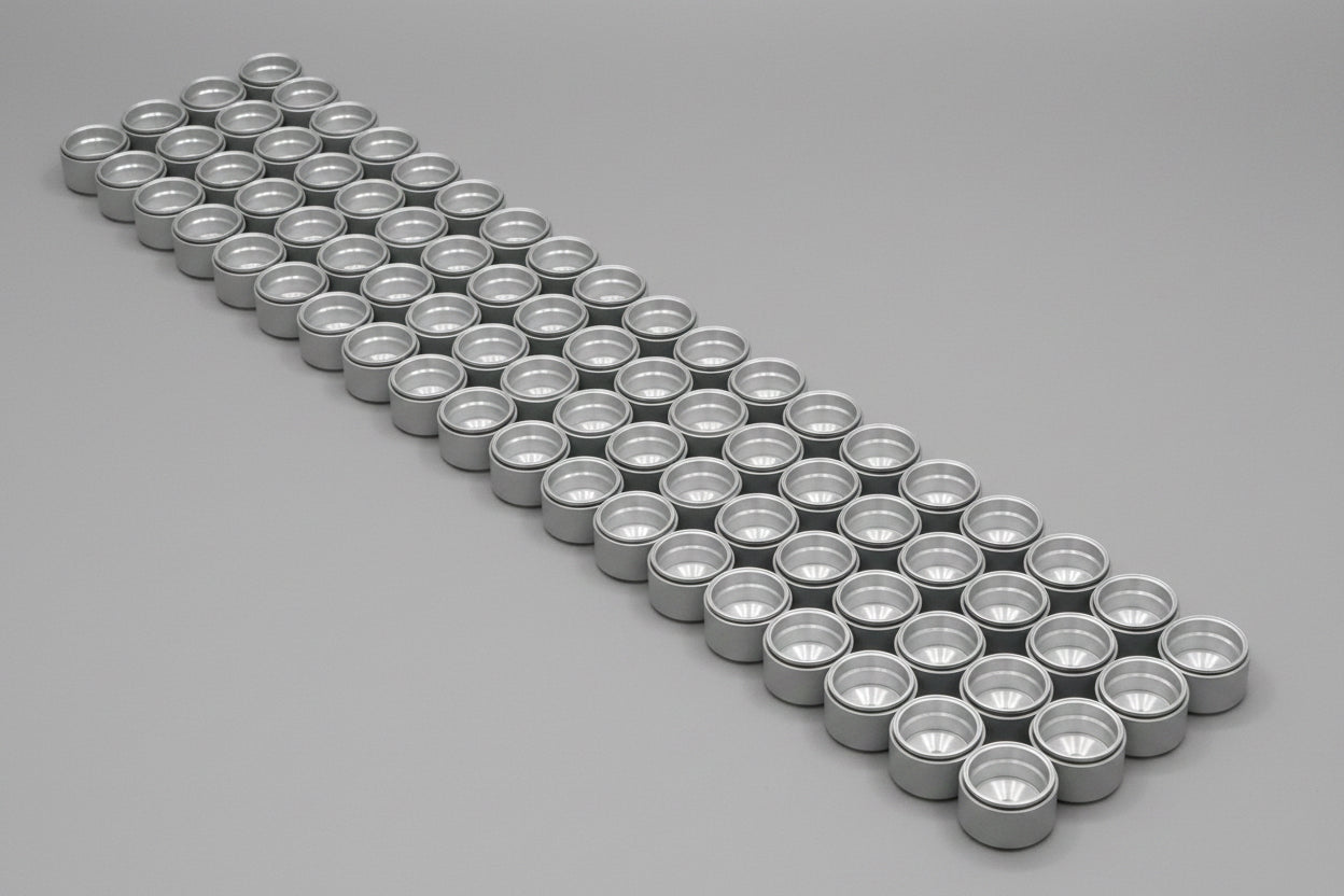 Row of metallic cylindrical objects on a gray background