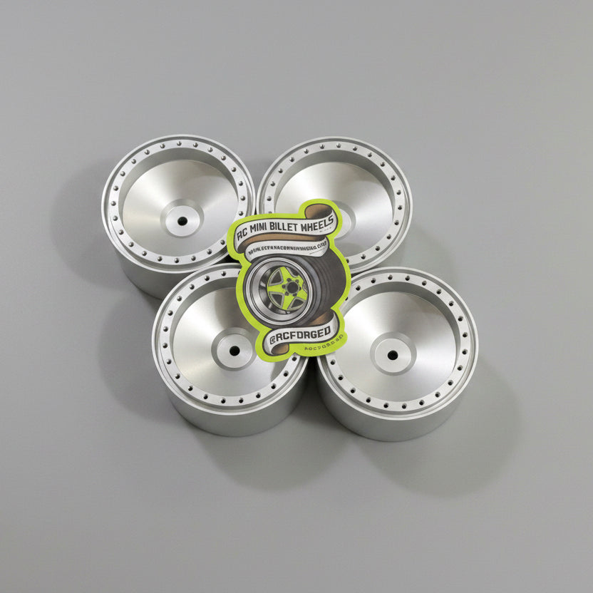Five silver hubcaps on a dark wooden surface with a visible brand label.
