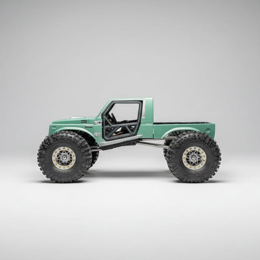 Model of a green off-road vehicle with large wheels on a textured surface.
