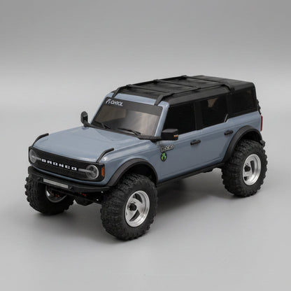 Model of a blue SUV with large wheels on a gray surface
